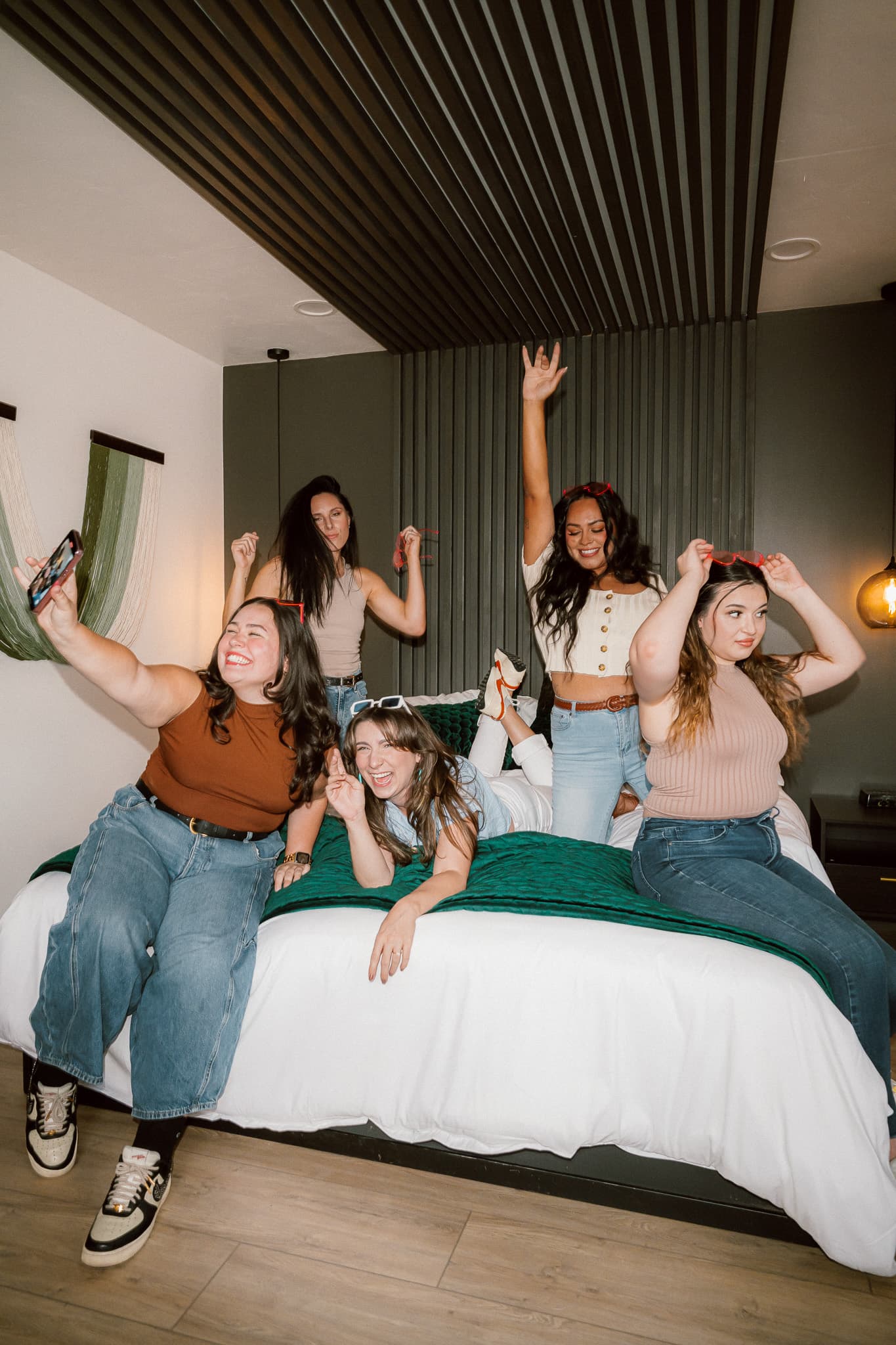 Group of girls taking a selfie in an Arcadia Hotel room